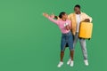Positive young black couple going vacation, holding passports, suitcase Royalty Free Stock Photo