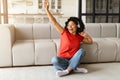 Positive young black woman listening to music on headphones and dancing joyfully Royalty Free Stock Photo