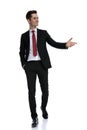 Positive young businessman presenting and smiling Royalty Free Stock Photo