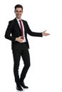 Positive young businessman presenting to the side Royalty Free Stock Photo