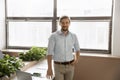 Positive Caucasian business owner man standing at office desk Royalty Free Stock Photo