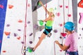 Couple of alpinist practicing in pair indoor rock-climbing Royalty Free Stock Photo