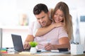 positive young couple embracing and calculating bills at home Royalty Free Stock Photo