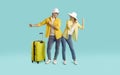 Positive young couple having fun and dancing going on summer trip isolated on light blue background. Royalty Free Stock Photo