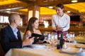 Positive young couple making order at restaurant Royalty Free Stock Photo