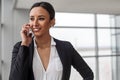 Positive young elegant woman is talking on smartphone Royalty Free Stock Photo