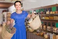 Young woman displaying two bags with purchases and smiling in biofood store Royalty Free Stock Photo