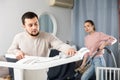 Young couple cleaning table in living room Royalty Free Stock Photo