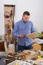 young male carpenter working wood plank at workshop Royalty Free Stock Photo