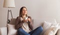 Positive young girl enjoying smell of fresh hot coffee Royalty Free Stock Photo