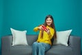 Positive young girl using mobile phone with focused expression, playing game on cellphone. Leisure and technology Royalty Free Stock Photo