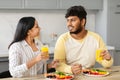 Positive young indian spouses enjoying breakfast together at home Royalty Free Stock Photo