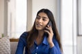 Positive young Indian woman talking on mobile phone Royalty Free Stock Photo
