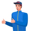 Positive young man making thumbs up sign with both hands. Guy in a sports sweatshirt with and a cap Royalty Free Stock Photo