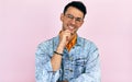 Positive young man thinking an idea posing over isolated pink background. Male wearing stylish casual clothes, transparent Royalty Free Stock Photo