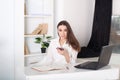 Positive young manager working on business project in office.The girl calls on the phone. Close-up portrait of an office worker. C Royalty Free Stock Photo