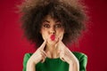 Positive young woman with curly hair grimace posing emotion color background unaltered Royalty Free Stock Photo