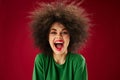 Positive young woman with curly hair grimace posing emotion studio model unaltered