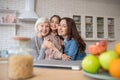 Young woman,elderly woman and little girl embraced smiling.