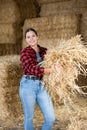 Cheerful woman farmer holding bunch of hay Royalty Free Stock Photo