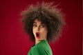 Positive young woman grimace afro hairstyle red lips fashion color background unaltered Royalty Free Stock Photo