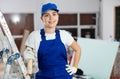 Smiling woman repairer standing inside apartment Royalty Free Stock Photo