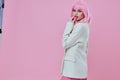 Positive young woman in White blazer pink hair Glamor Cosmetics color background unaltered Royalty Free Stock Photo