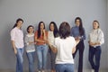 Positive young women listening to an interesting motivational speech by professional coach Royalty Free Stock Photo