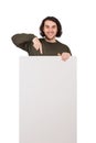 Positively surprised man pointing index finger to blank announcement banner, looking amazed to camera. Contented guy and empty Royalty Free Stock Photo