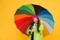 Positivity concept. Rainy day fun. Happy walk under umbrella. Enjoy rain concept. Kid girl happy hold colorful rainbow Royalty Free Stock Photo
