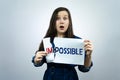 Positivity concept, woman tearing word impossible to make possible