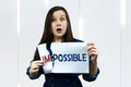 Positivity concept, woman tearing word impossible to make possible Royalty Free Stock Photo