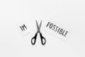 It is possible concept. Word Impossible becomes Possible with scissors