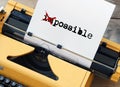 Possible impossible - word on sheet of paper written on yellow typewriter Royalty Free Stock Photo