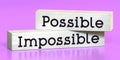 Possible, impossible - words on wooden blocks