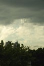 Cumulus clouds over the city.Possible rainfall Buildings surrounded by trees Royalty Free Stock Photo