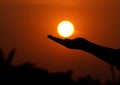 Is it possible to hold the sun above your hand but it is possible to capture the sun just like in the picture