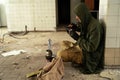 Post apocalypse, survivor, war. A man sitting in an abandoned building with a weapon. Stalker with a gun is resting. Royalty Free Stock Photo