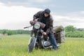 A post apocalyptic man on motorcycle in a meadow Royalty Free Stock Photo