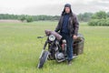 A post apocalyptic man on motorcycle in a meadow Royalty Free Stock Photo