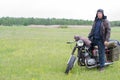 A post apocalyptic man on motorcycle in a meadow Royalty Free Stock Photo