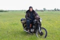 A post apocalyptic man on motorcycle in a meadow Royalty Free Stock Photo