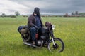 A post apocalyptic man on motorcycle in a meadow Royalty Free Stock Photo