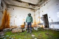 Dramatic portrait of a man wearing a gas mask in a ruined building