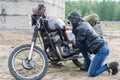 A post apocalyptic woman near motorcycle near the destroyed building Royalty Free Stock Photo