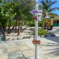 A post with arrows showing what direction and how many miles Half Moon Cay, Bahamas is from Fort Lauderdale, FL Royalty Free Stock Photo