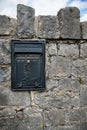 post box, embedded in a stone wall Royalty Free Stock Photo