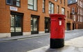 post box in london street with red houses Royalty Free Stock Photo