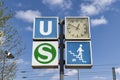 post with a clock and signs for s-bahn and u-bahn in a German city Royalty Free Stock Photo
