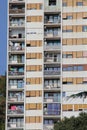 Post-communist block, block with lots of balconies and windows, high skyscraper, windows covered with roller shutters, laundry han